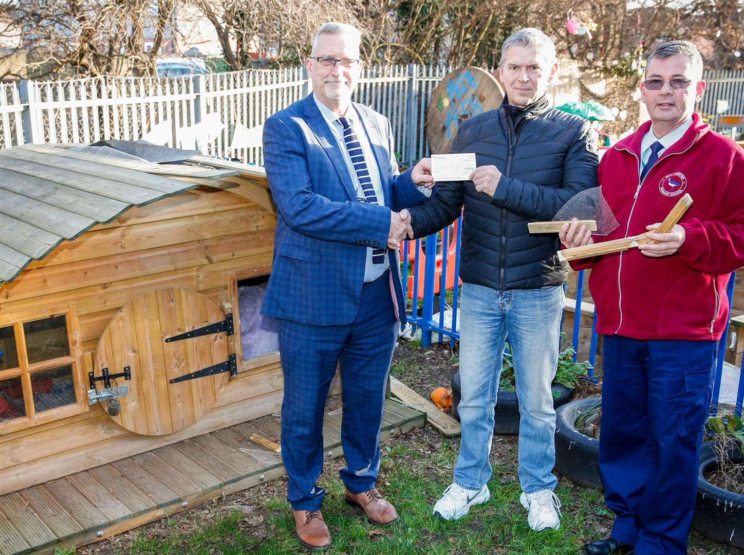 Glen Harden, centre, from Windsor Furniture presents a cheque for £1,000 to school head Steve Davies and caretaker Martin Walker