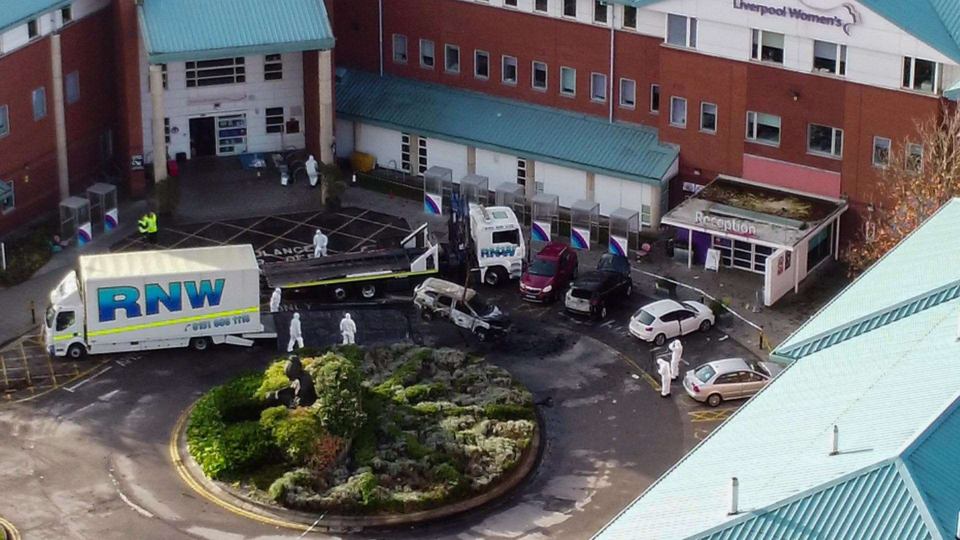 Aerial view of damaged car being removed by forensic officer after the explosion at the Liverpool Women’s Hospital