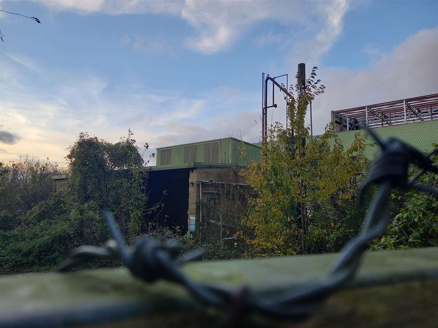 Barbed wire surrounds the site's perimeter