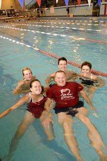 kmfm presenter Johnny Lewis (centre) at the sponsored swimathon at Hartsdown Leisure Centre, Margate