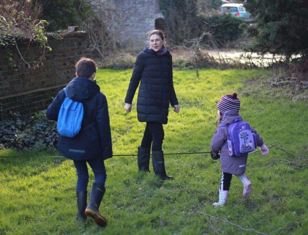 Robin Schuldenfrei, centre, with son Theo left, and friend Polina, right. Garden of Bridge House, banks of the river.