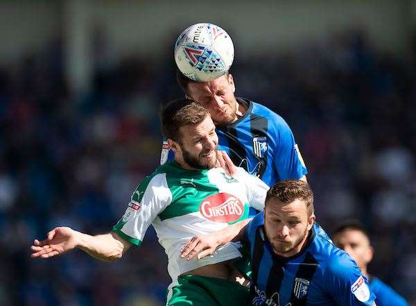 Gillingham's Luke O’Neill beats David Fox to a header Picture: Ady Kerry (8902365)