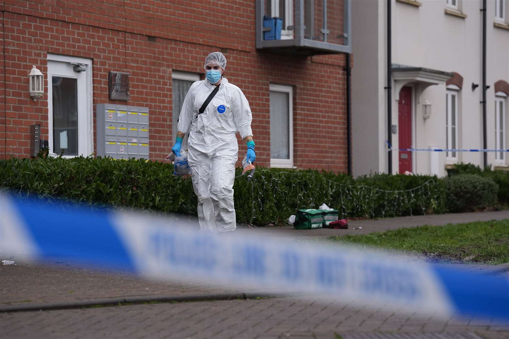 A police cordon and a forensic officer at the scene in Newton Leys (Joe Giddens/PA)