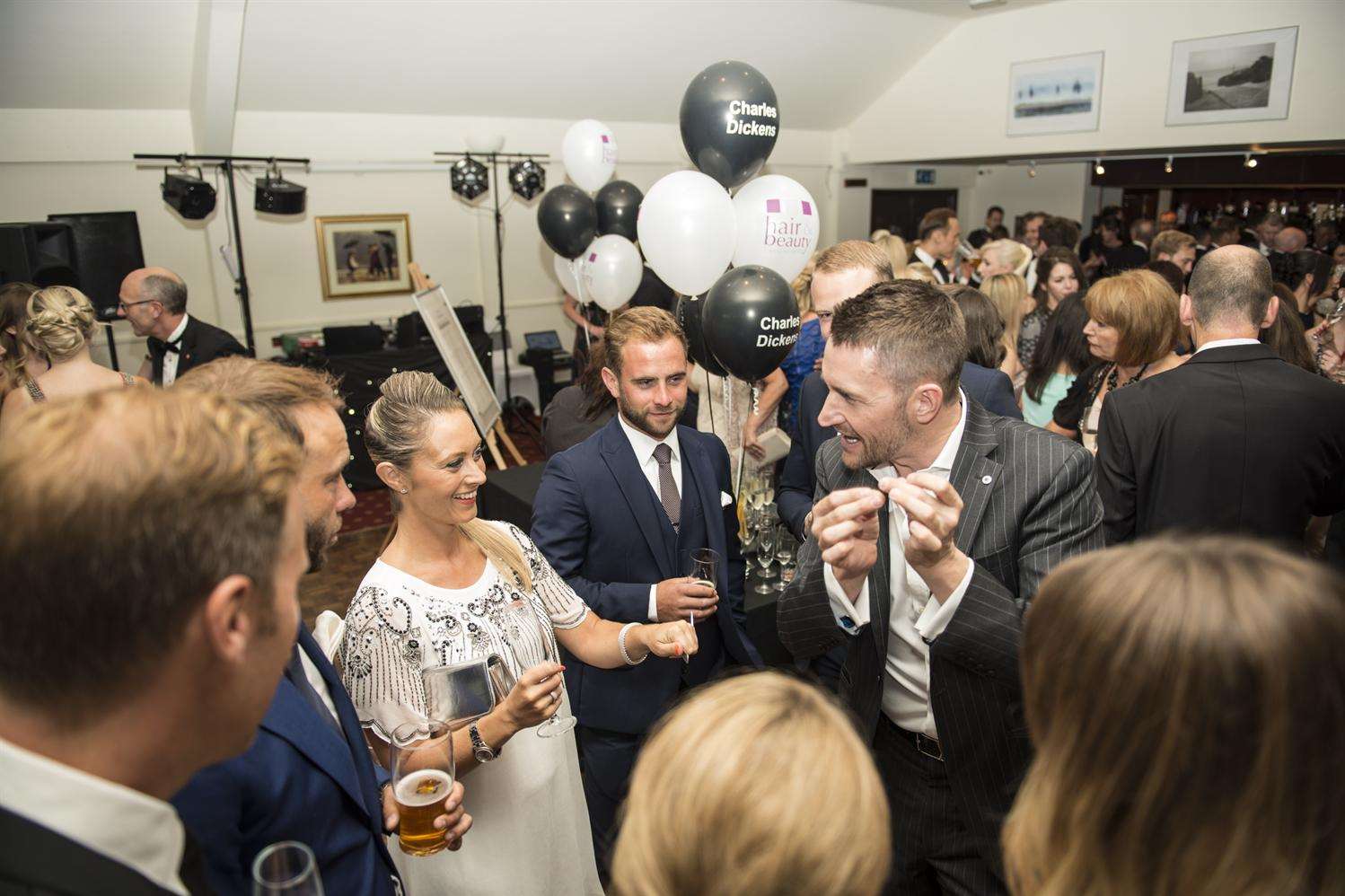 A magician entertains a crowd at the ball Credit:Jacob Niblett photography