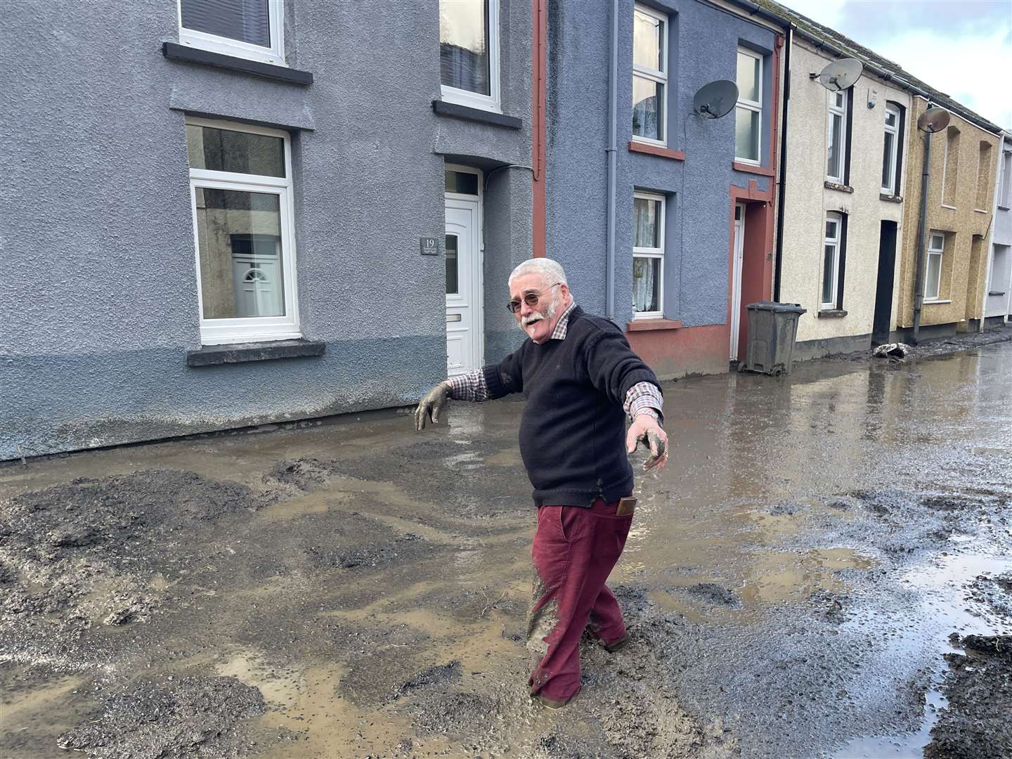 Rob Scholes, 75, was pictured walking through sludge as an apparent mud slide forced people from their homes in Cwmtillery in Wales (George Thompson/PA)