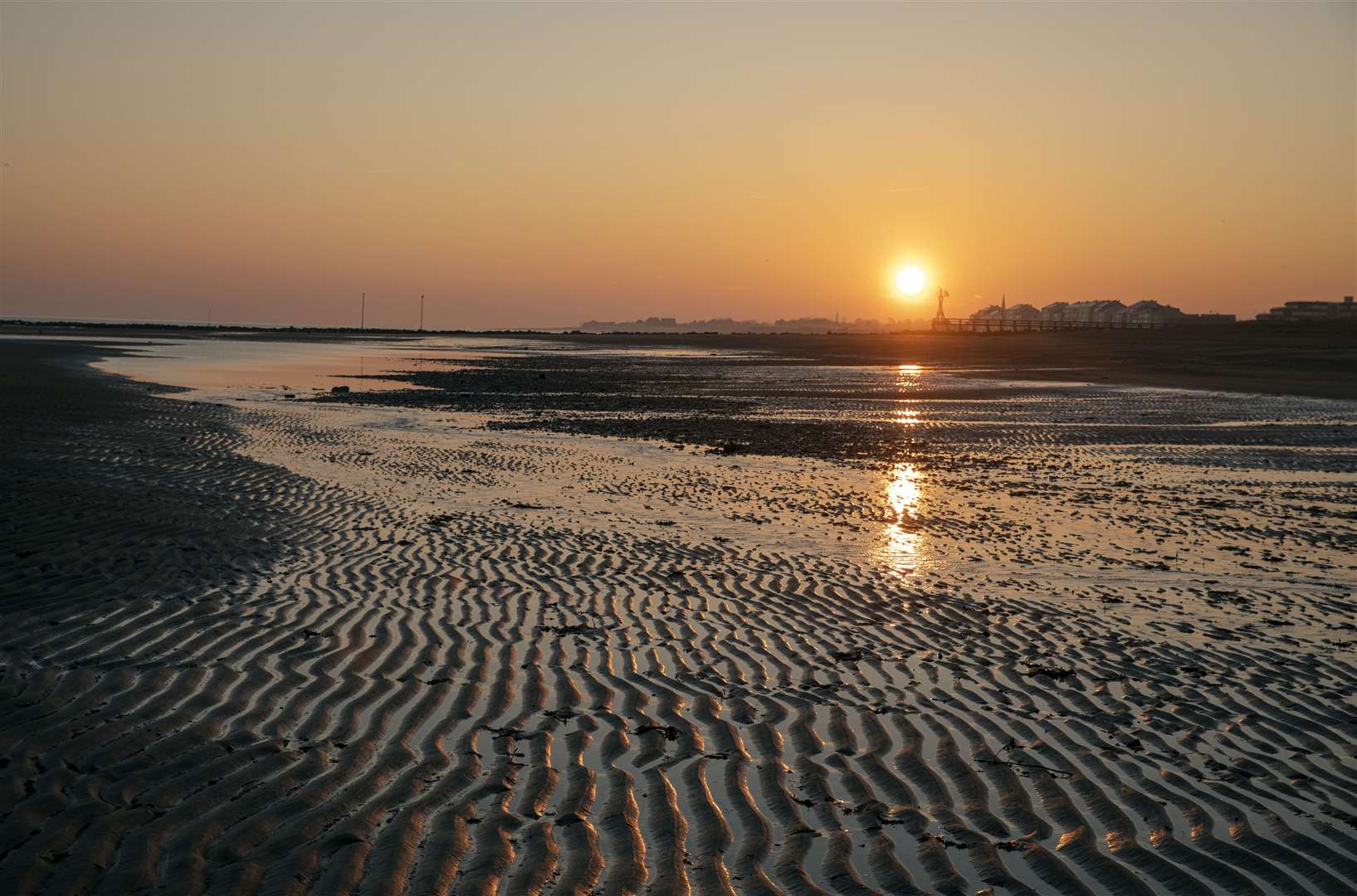 The sun rises over Juno beach near Graye-sur-Mer in France (PA)