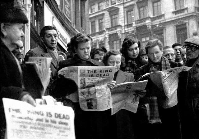 People in Ludgate Circus, London, reading about the King's death. Picture: PA