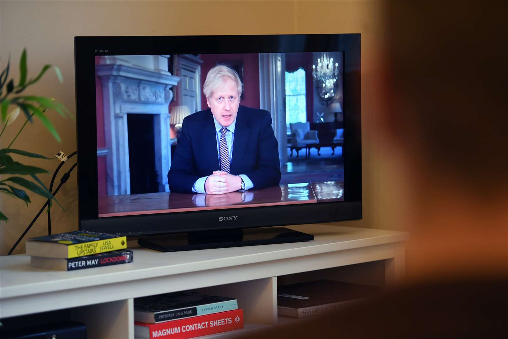 People in Wandsworth, London watching Prime Minister Boris Johnson addressing the nation (Kirsty O’Connor/PA)