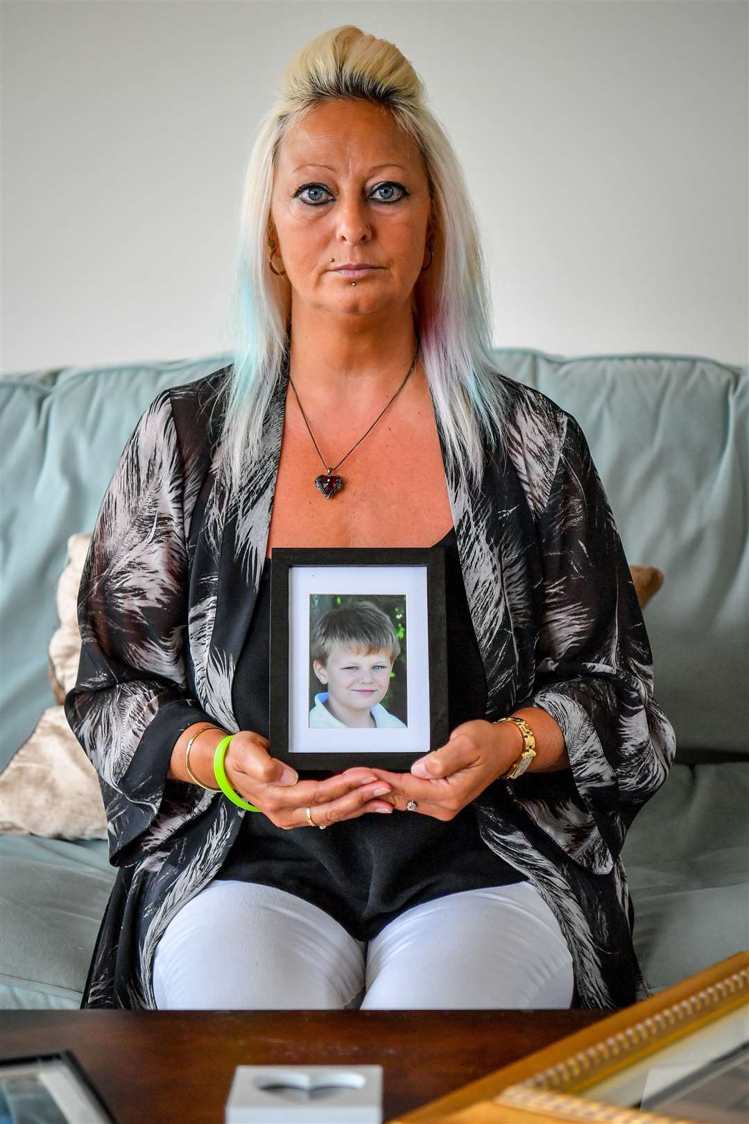 Harry Dunn’s mother, Charlotte Charles, holds a photograph of him aged 14 (Family handout/PA)