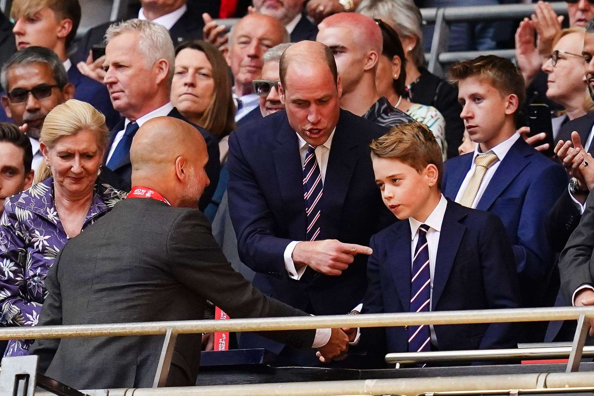 The Prince of Wales and Prince George speak with Manchester City manager Pep Guardiola following the Emirates FA Cup final at Wembley (John Walton/PA)