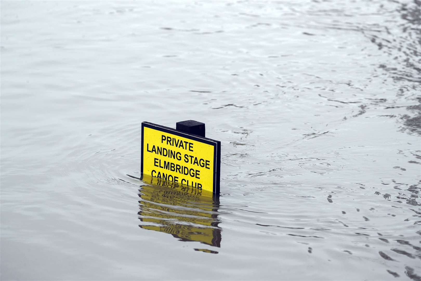 A partly submerged sign in Weybridge, Surrey, on Monday (Steve Parsons/PA)