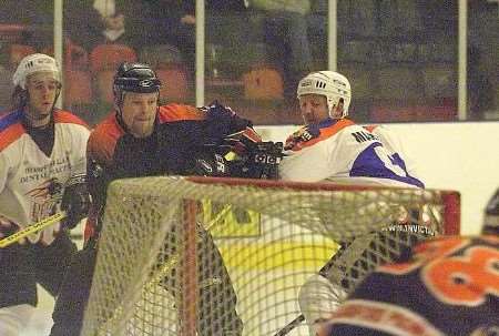 TUSSLE: Peter Korff (left) and Andy Martin (right) hold off ex-Dynamo Andy Hannah. Picture: DAVE TREVELLIAN