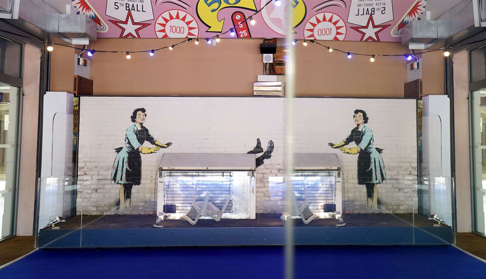 A view of Banksy’s pop-up artwork, Valentine’s Day Mascara, reflected in a mirror following its installation at Dreamland Margate (Gareth Fuller/PA)