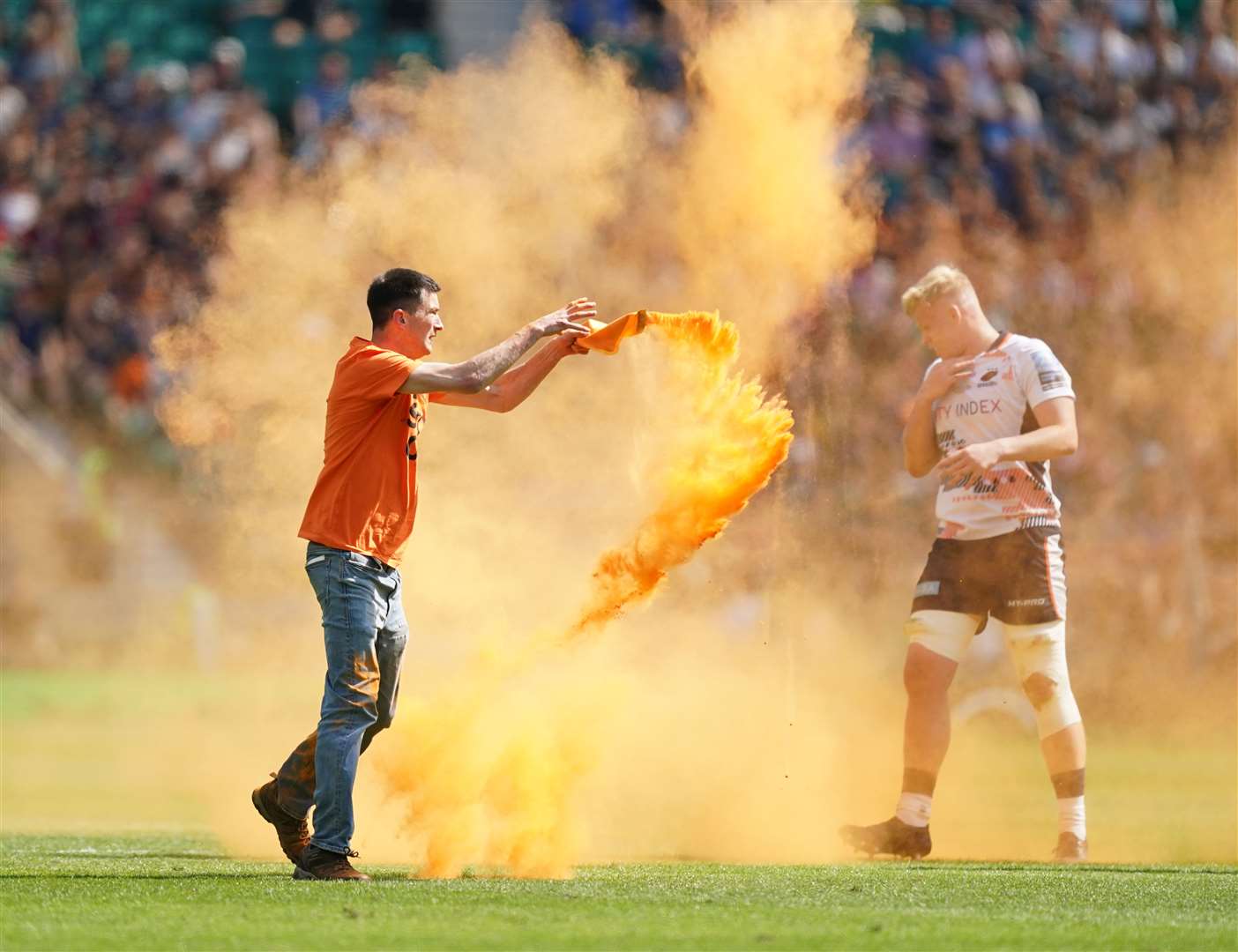 A Just Stop Oil demonstrator throws orange powder on the pitch during the Gallagher Premiership final at Twickenham Stadium (Mike Egerton/PA)