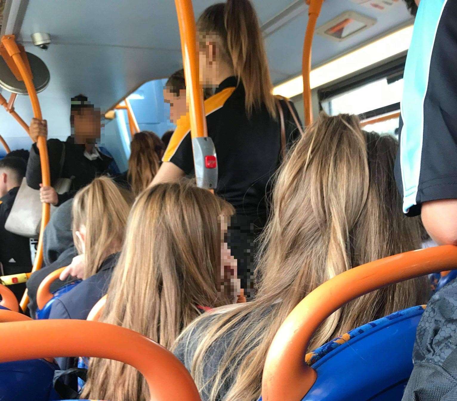 Youngsters can be seen standing in the aisles without face masks