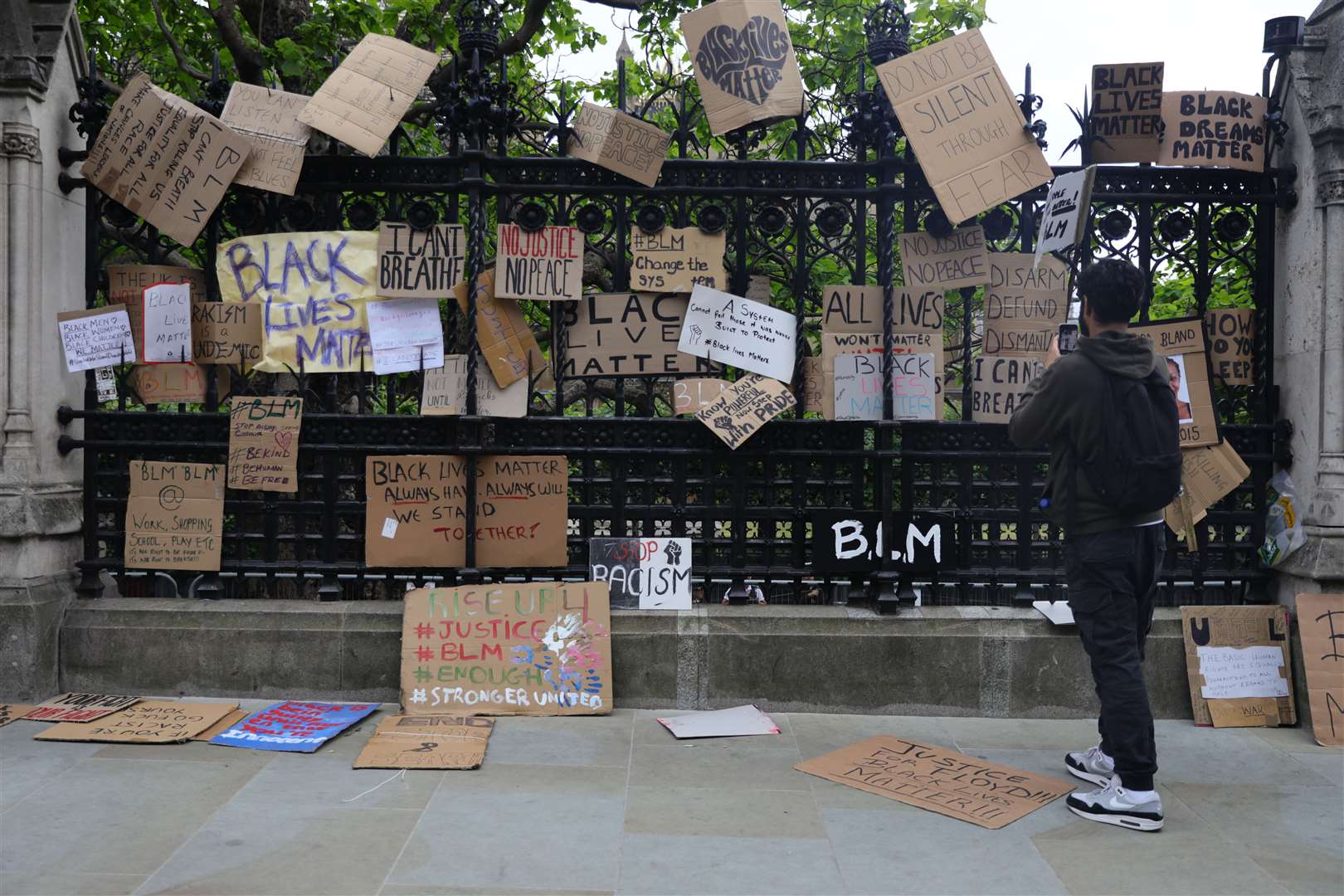 Protesters placed signs on the fence of the Houses of Parliament (Aaron Chown/PA)