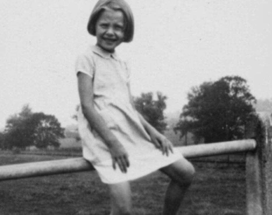 Audrey Hepburn sitting on the railings of the Elham Valley Railway bridge at Ottinge. Picture: Elham Historical Society/Hepburn Family Collection