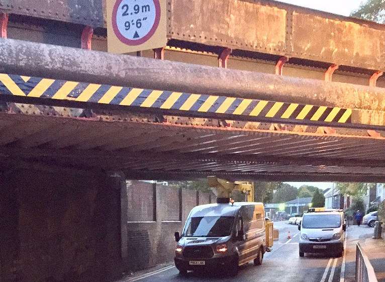 The cherry picker wedged under the bridge