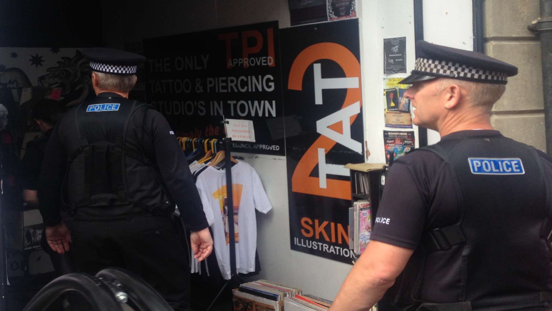 Officers enter a store in Canterbury