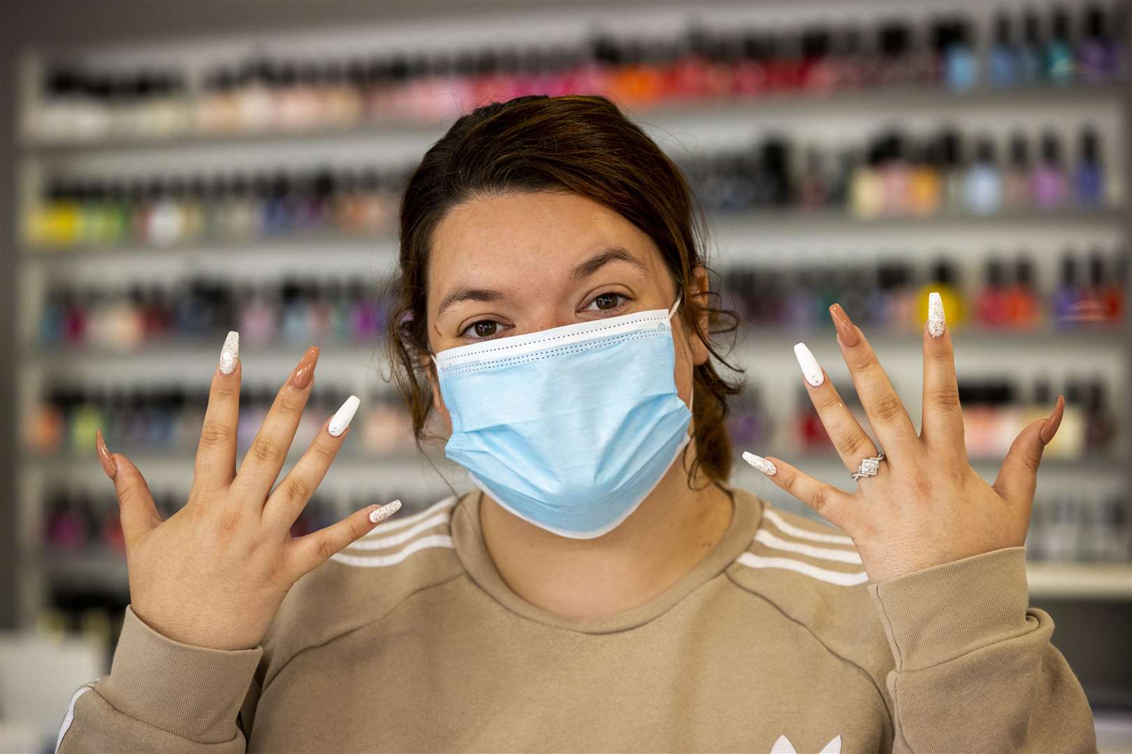 Paige Hegarty shows off her nails after visiting the Hollywood Nail Salon in Belfast (Liam McBunrey/PA)