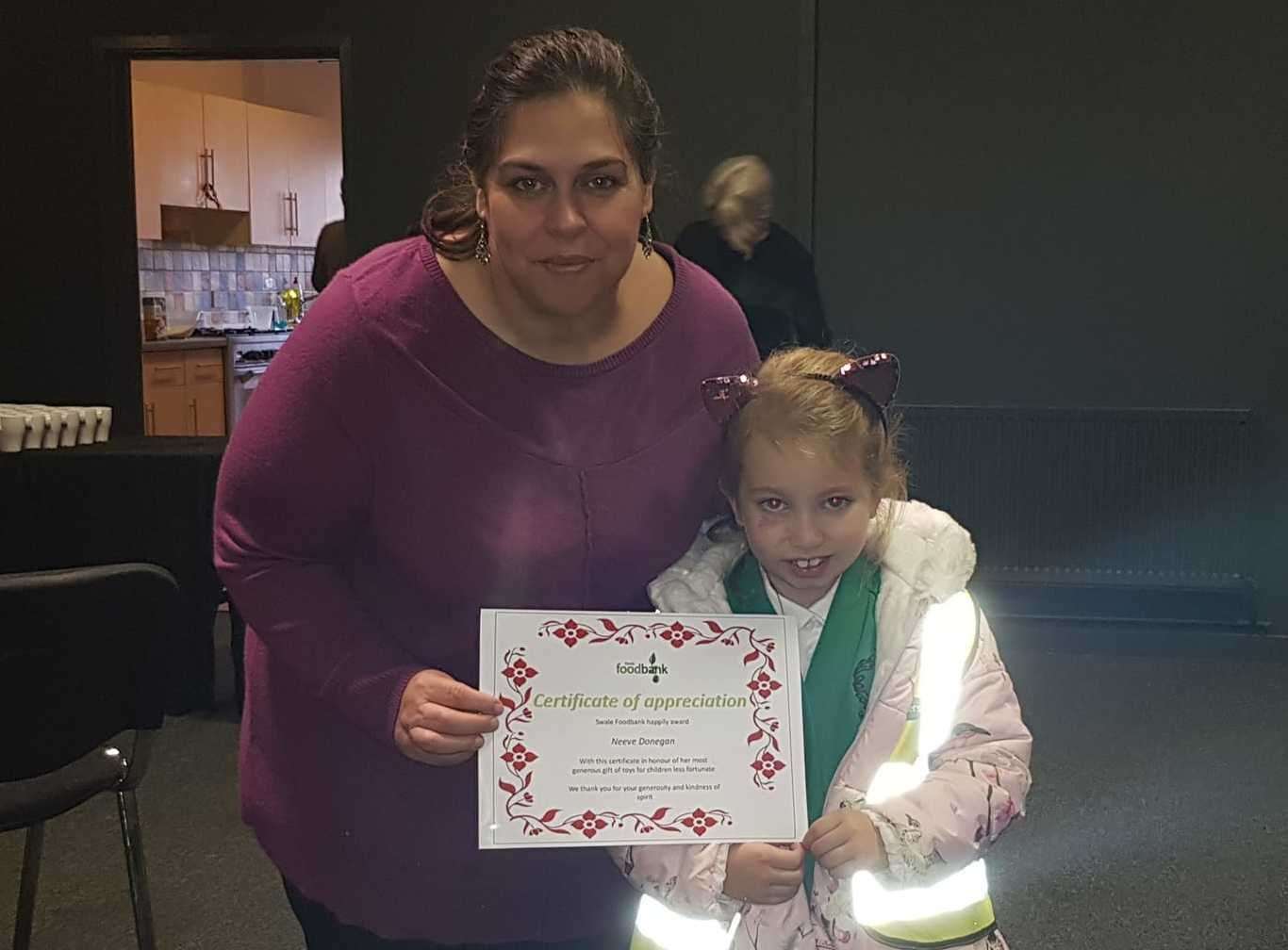 Swale Foodbank's Esther Hurwood with seven-year-old Neeve Donegan