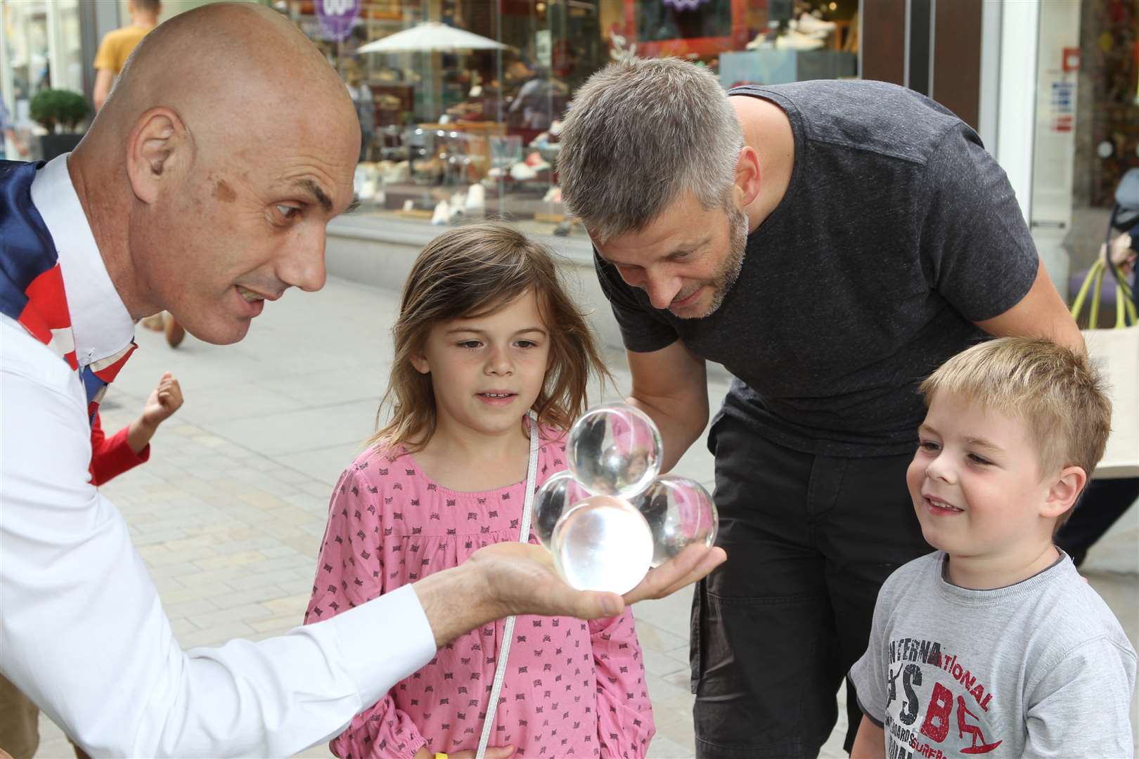 Juggler Jason Maverick enthrals Mike Rogers and his children, Libby, seven and Harry, five