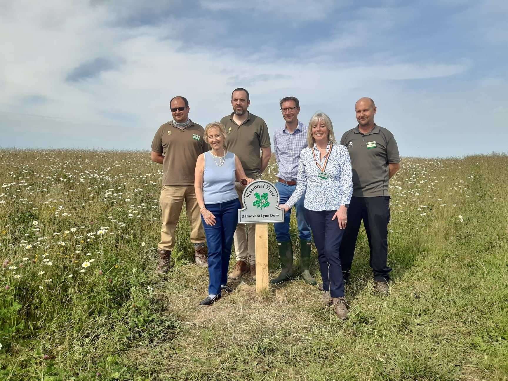 Dame Vera Lynn's daughter Virginia Lewis-Jones with National Trust staff who have been working to re-wild the meadow, now called Dame Vera Lynn Down