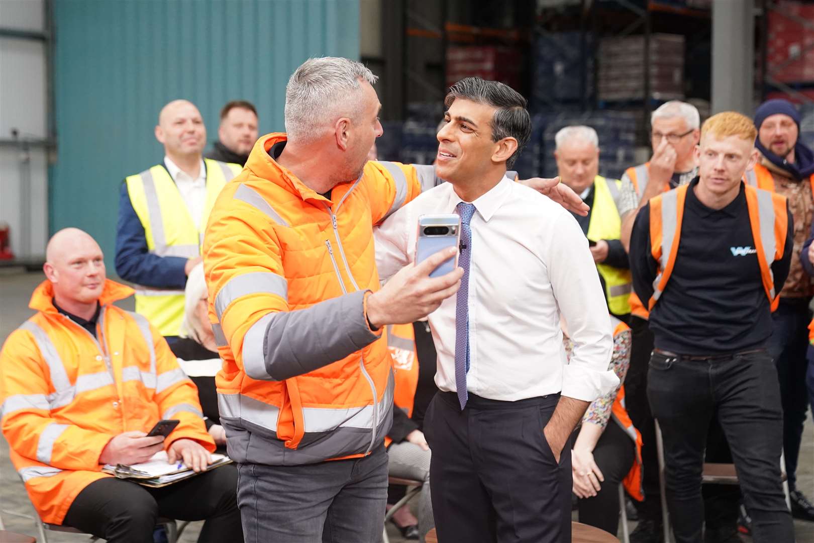 Mr Sunak was grabbed for a selfie during an earlier visit to answer questions from workers during a visit to West William Distribution in Ilkeston, Derbyshire (Stefan Rousseau/PA)