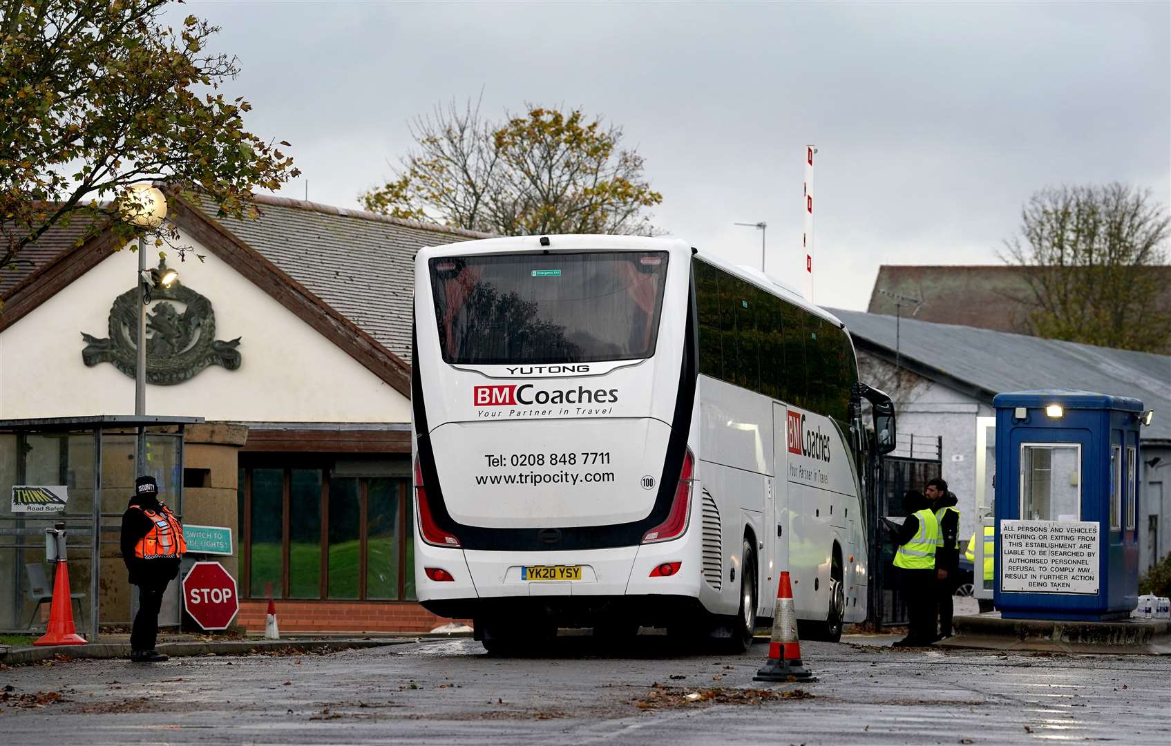 A coach arrives at the Manston immigration short-term holding facility (PA)