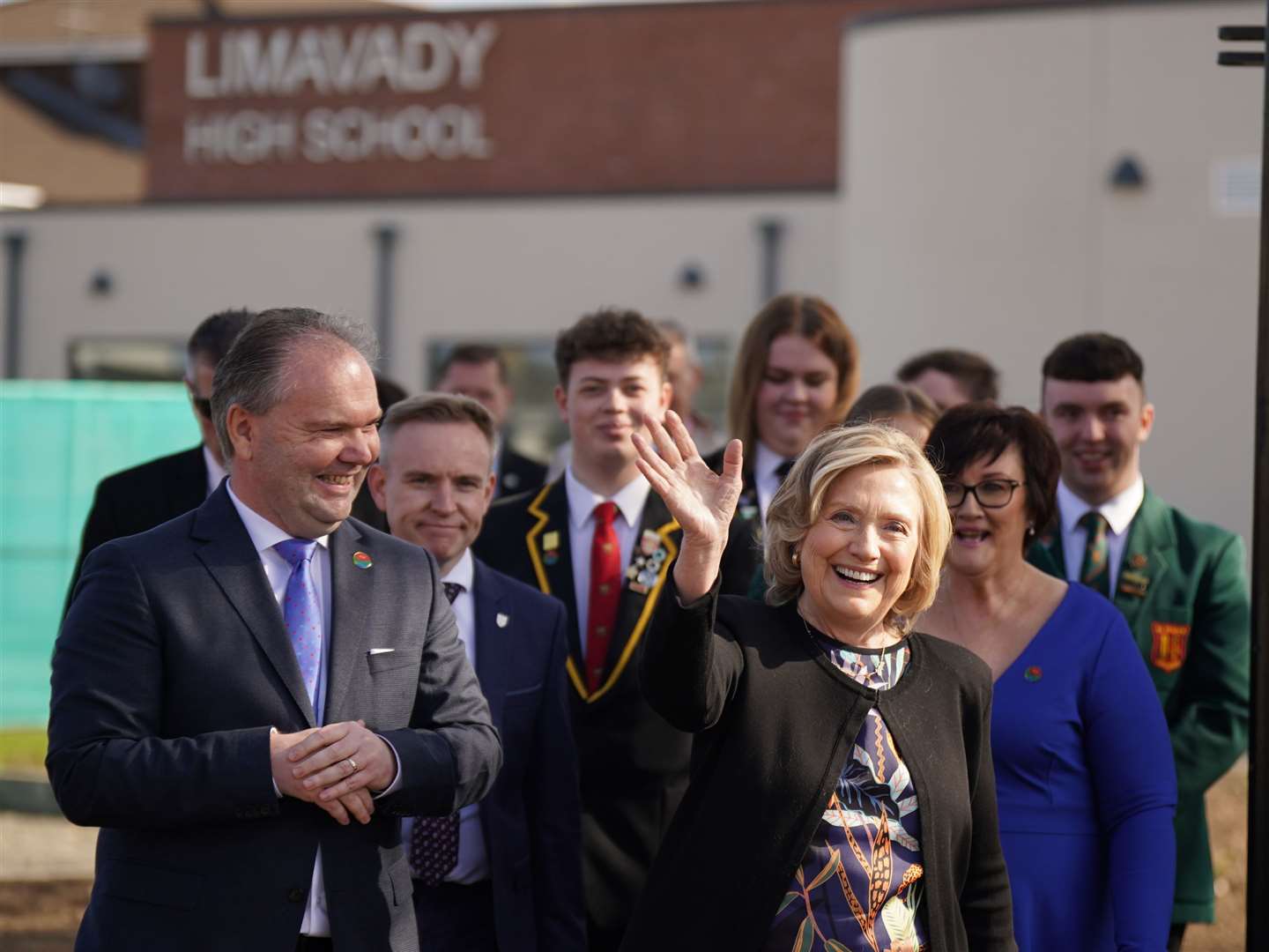 Hillary Clinton waves to the crowd as she visits Limavady High School to preside over an honorary graduation ceremony (Niall Carson/PA)