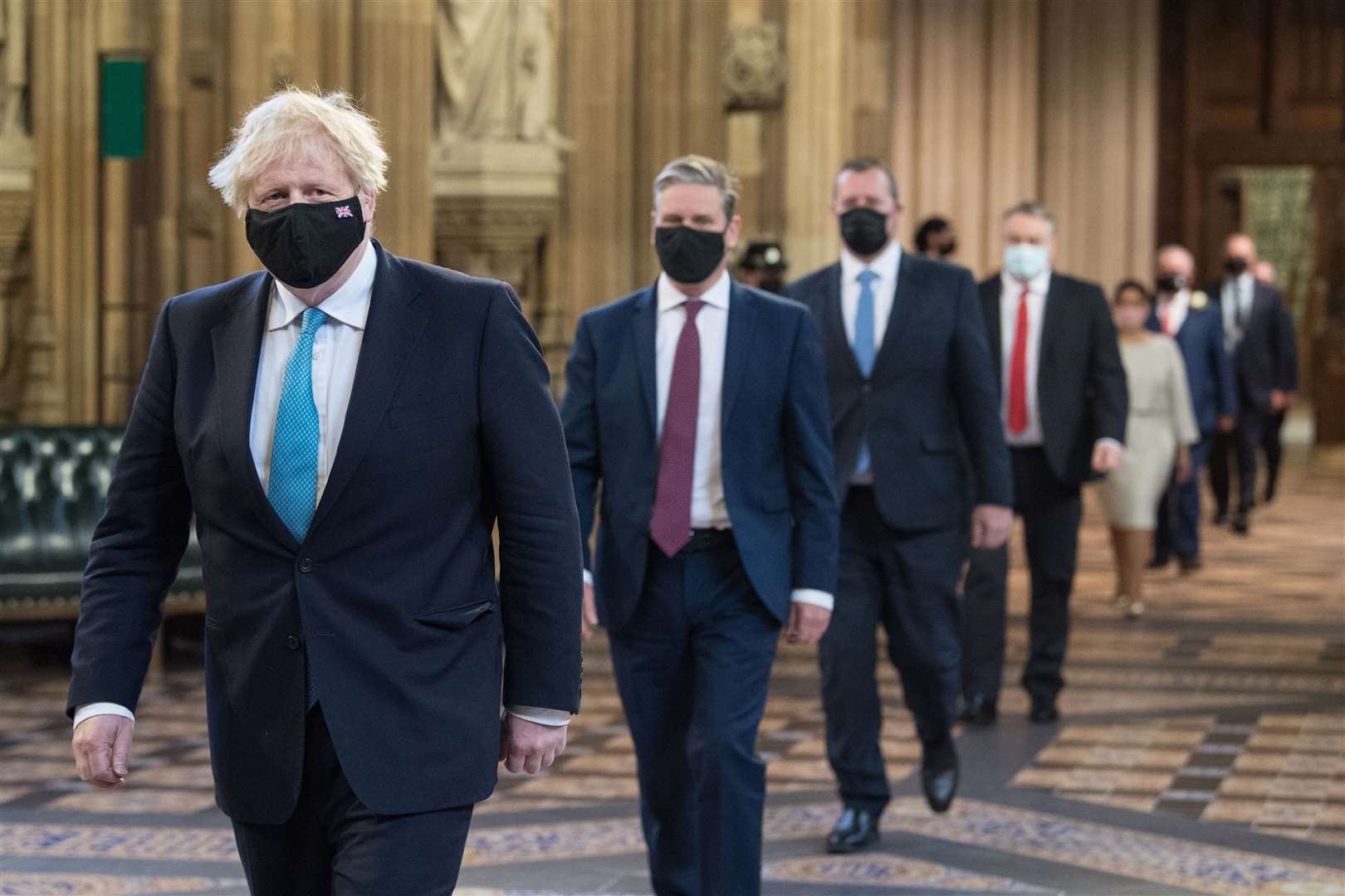 Prime Minister Boris Johnson and Labour leader Sir Keir Starmer walk through the Central Lobby on the way to the House of Lords to listen to the Queen’s Speech (PA)