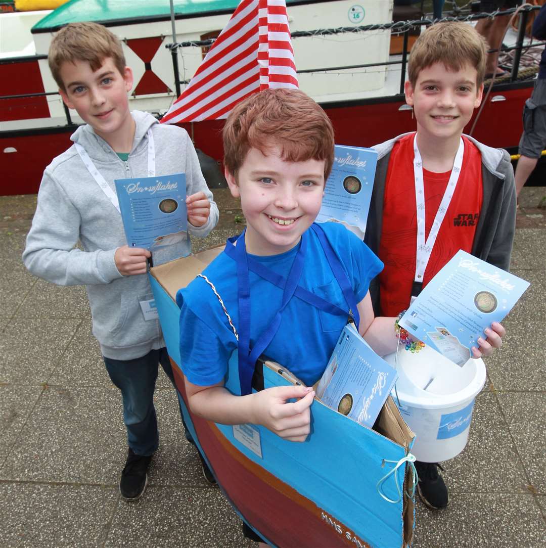 From left, George, 13, Sammy, 12 and Edward, 10 handing out leaflets for Snowflakes, a charity at the Maidstone River Festival 2019. Picture: John Westhrop