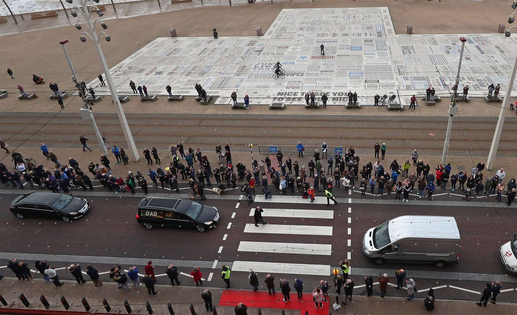 The funeral cortege passes the Comedy Carpet in front of the Blackpool Tower (Peter Byrne/PA)