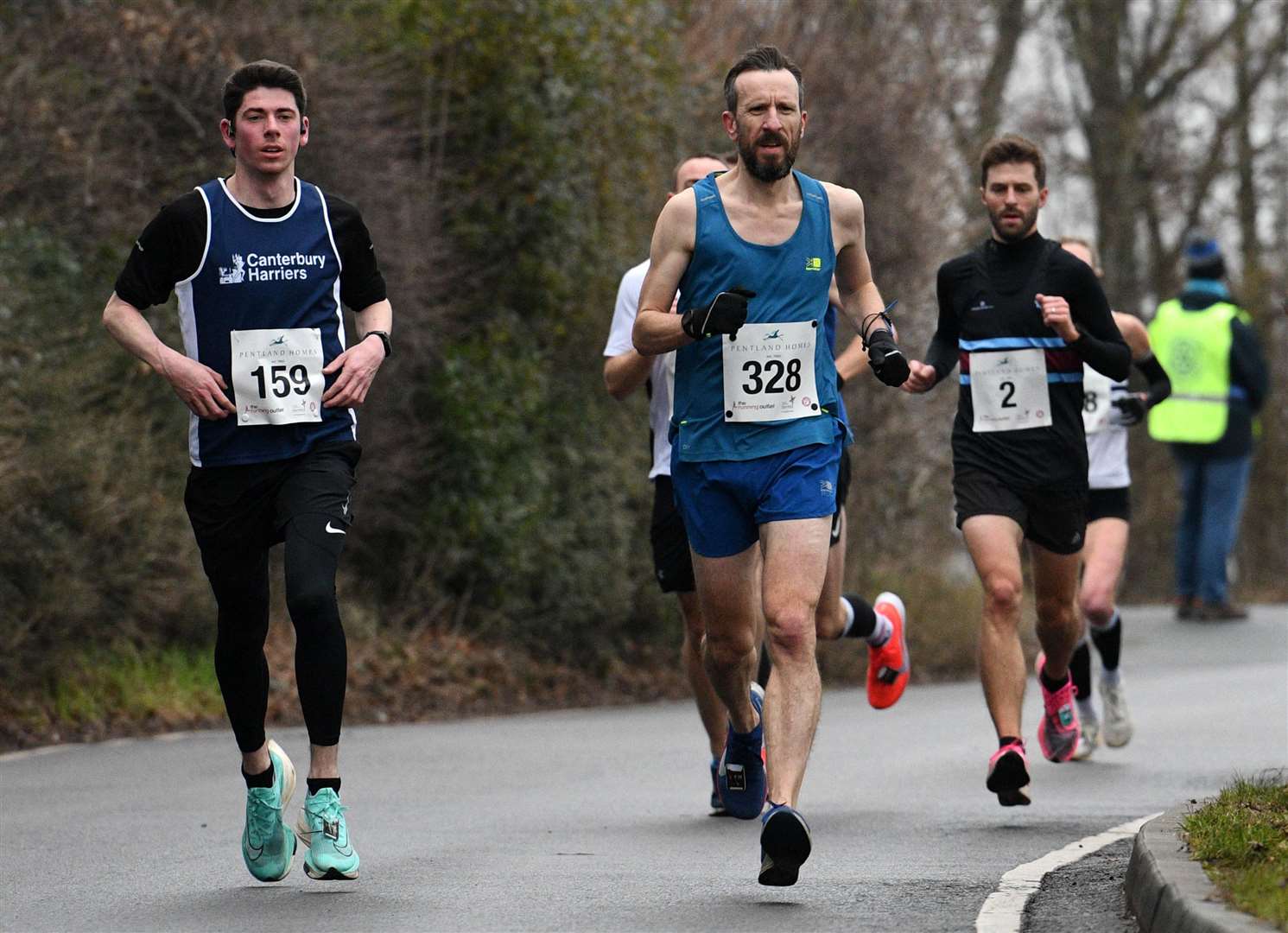 No.159 Henry Cox of Canterbury Harriers battles No.328 Lee Hardie. Picture: Barry Goodwin (54456175)