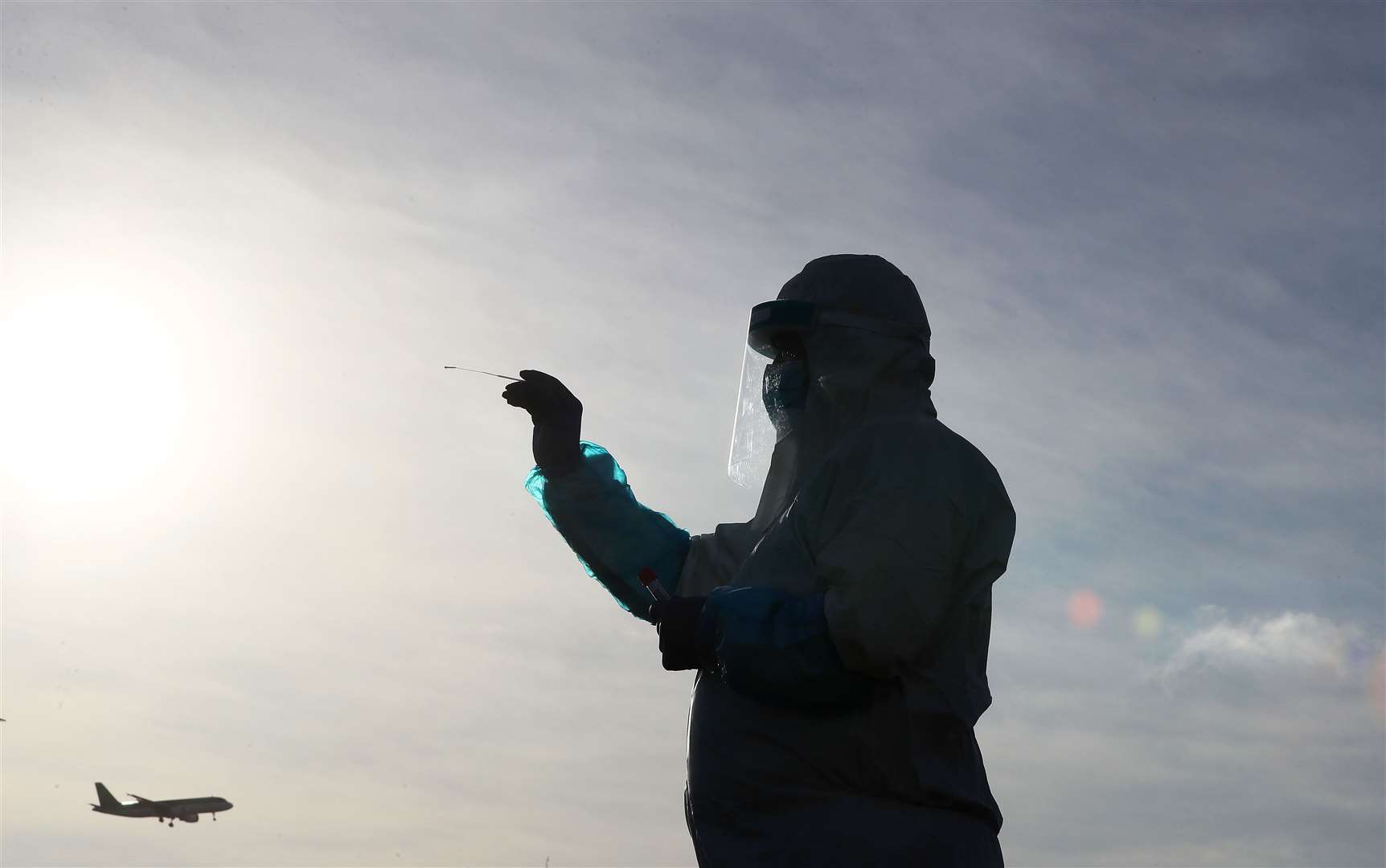 Darren Somers holds a swab at a drive-thru Covid-19 testing facility at Dublin Airport (Brian Lawless/PA)