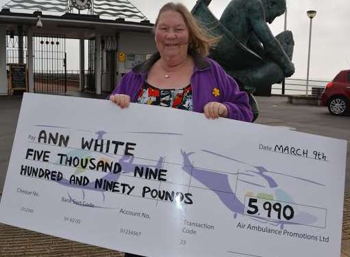 Ann White with her cheque on Deal seafront, at the foot of the pier