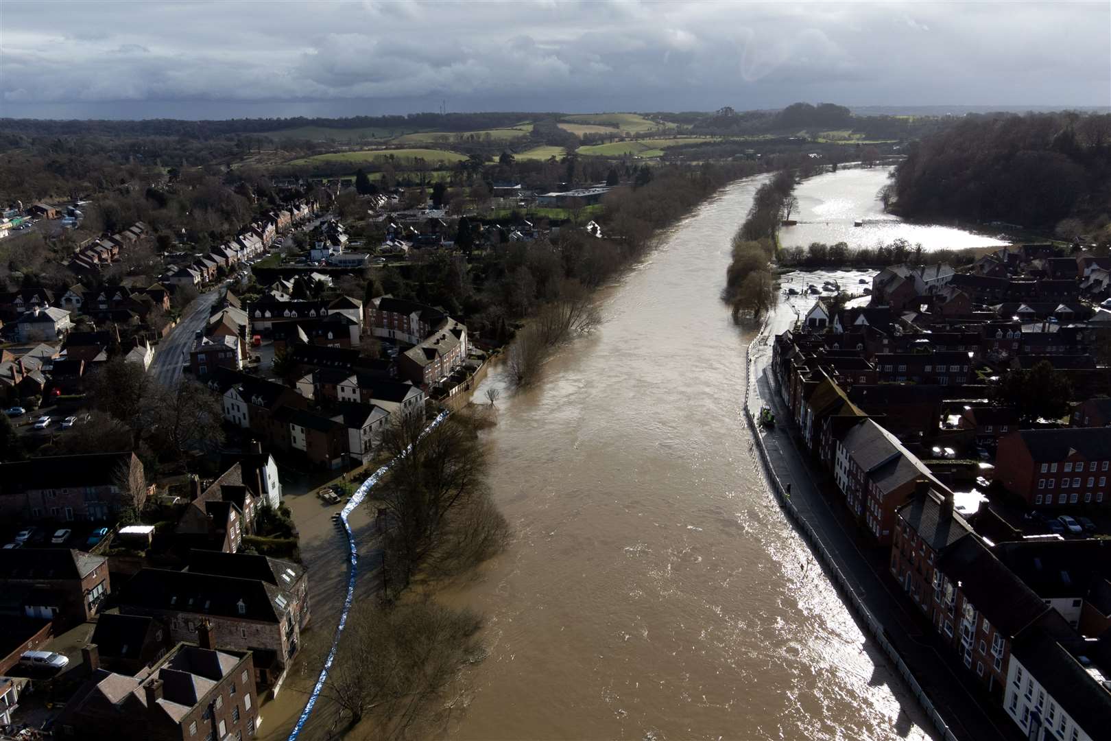 Water begins to spill behind flood defences along the River Severn at Bewdley in Worcestershire (Joe Giddens/PA)