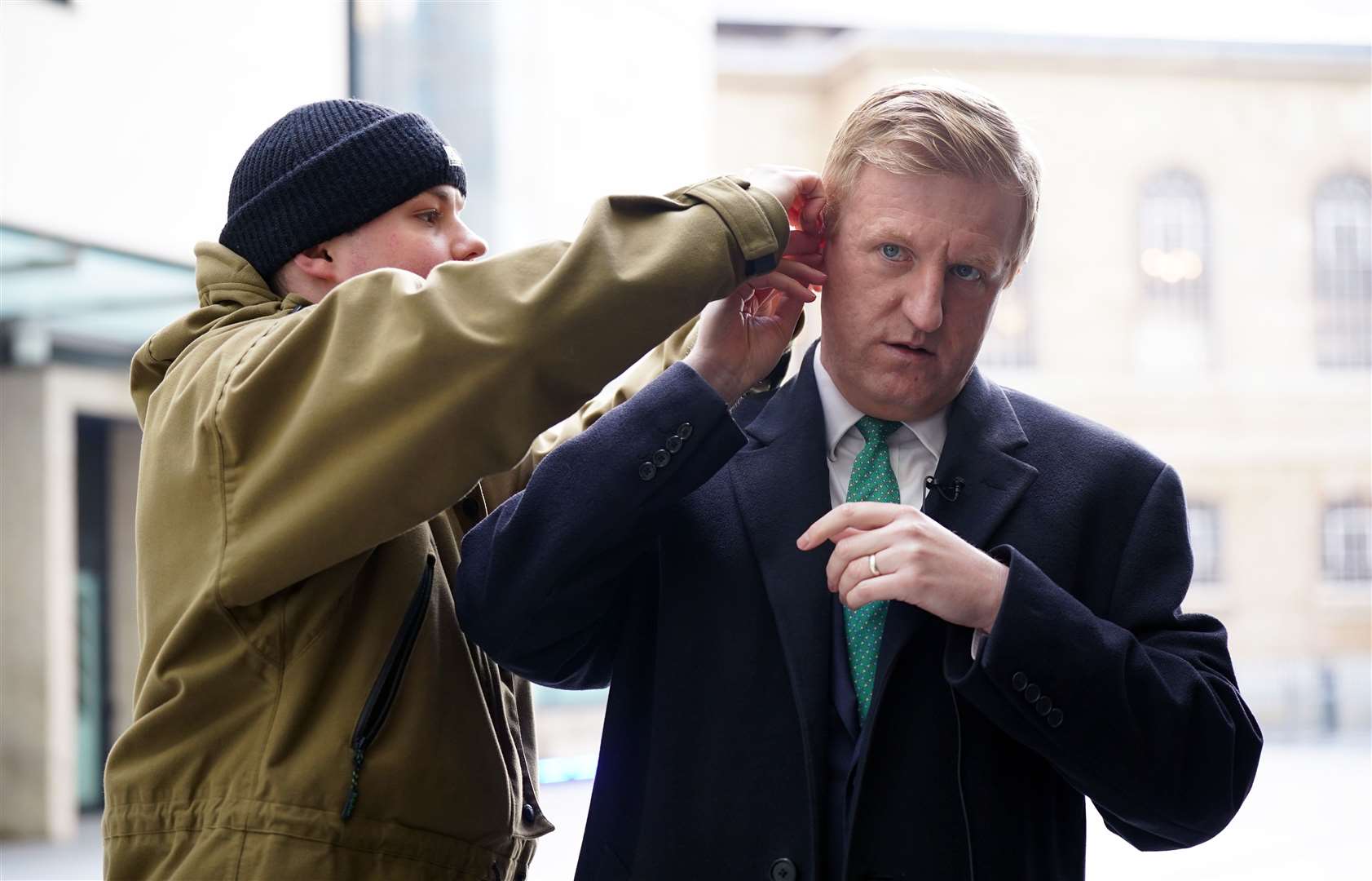 Hear! Hear! Oliver Dowden requires an adjustment of his earpiece before appearing on a television politics broadcast (Yui Mok/PA)