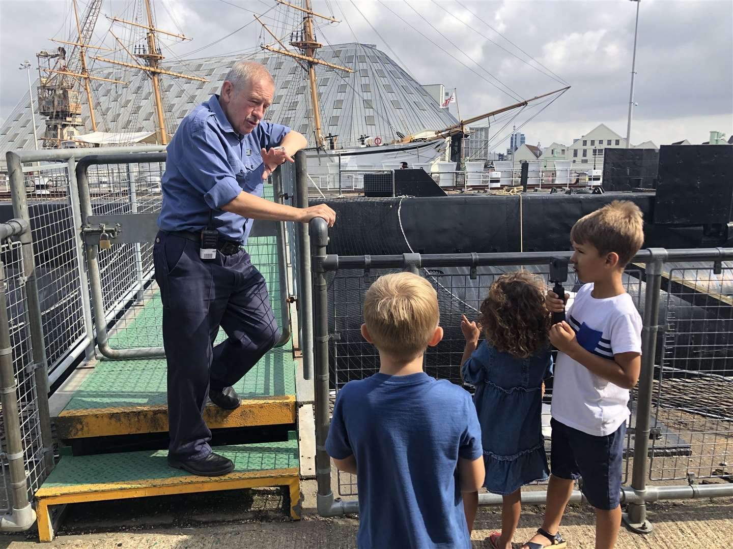 Children taking a tour of HMS Ocelot. Visitors go on board via the torpedo loading hatch