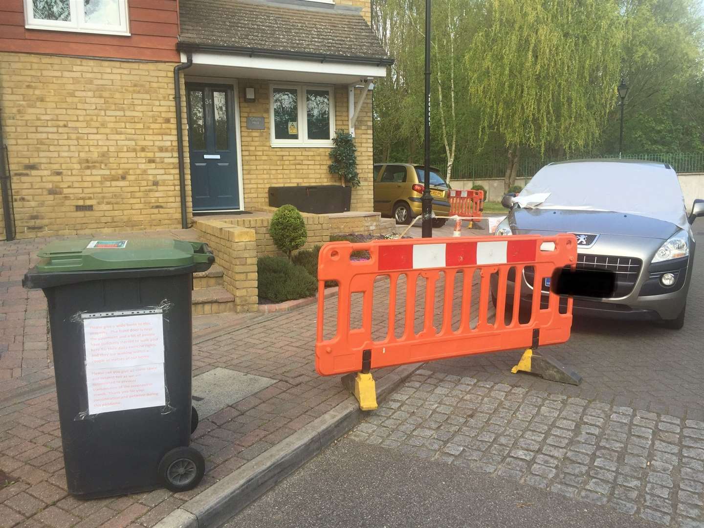 The barricades curve around the side of the house in Friars View