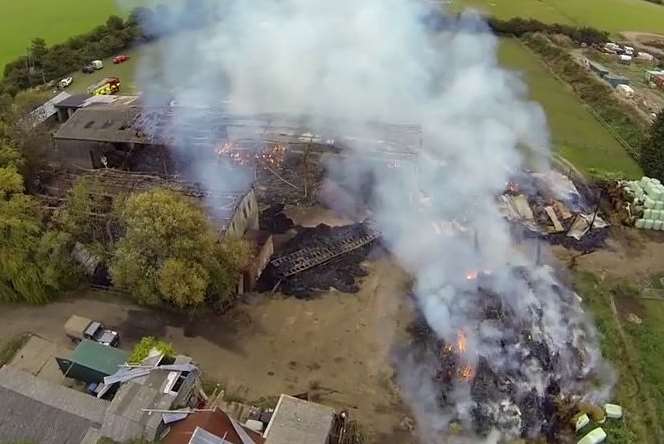 Piles of rubble smoulder at the Minster farm. Picture: Colin Spice/Kent Fire and Rescue Service