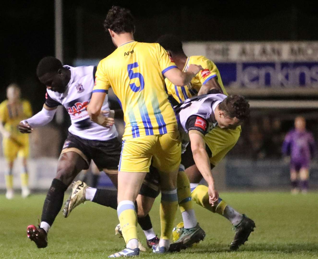 Deal pair Rory Smith and substitute Ife Oni are crowded out by Sittingbourne's scorer Jack Steventon. Picture: Paul Willmott