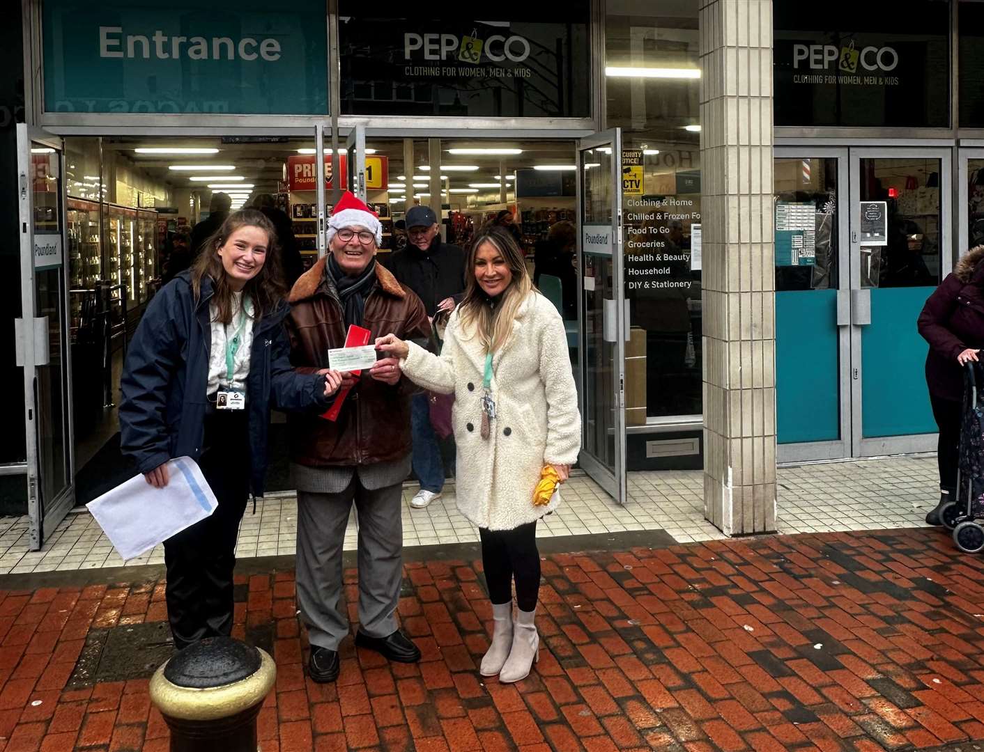 Dale Howting outside Poundland in Sittingbourne High Street with staff from Demelza. Picture: Hannah Corbett