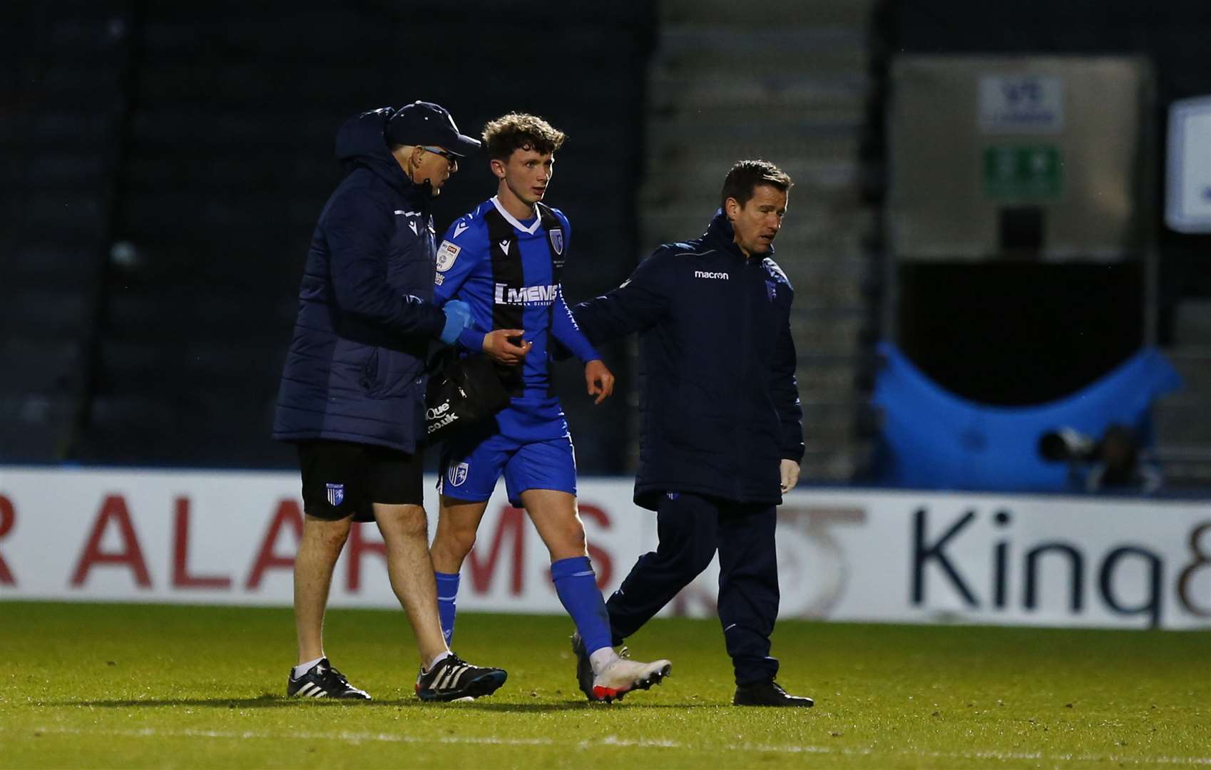 Gillingham midfielder Dan Adshead helped from the field on Saturday Picture: Andy Jones