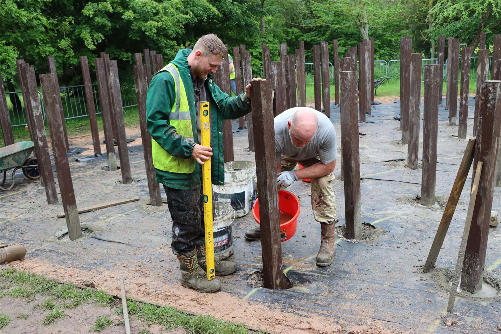 Workers refurbish the wooden posts at the memorial (National Memorial Arboretum/PA)