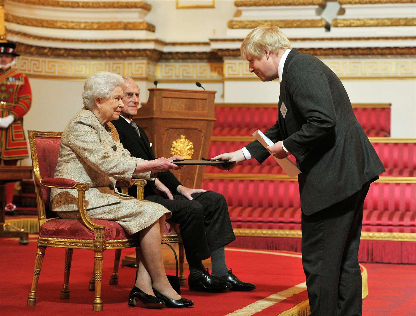 The late Queen accompanied by the Duke of Edinburgh receives a copy of the loyal address from Boris Johnson, during the event in 2012 (John Stillwell/PA)