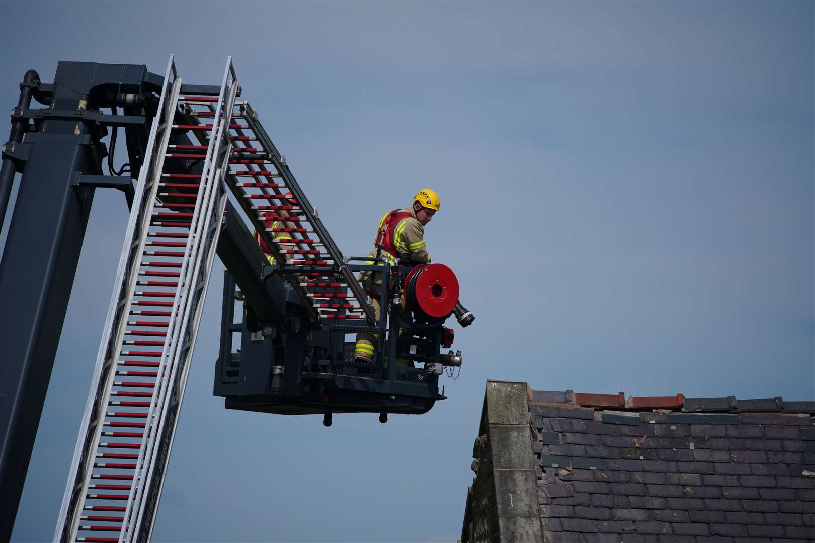 One house has been destroyed and several others have been significantly damaged as well as nearby cars (PA)