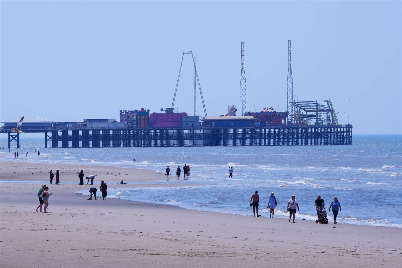People took advantage of the fine weather to enjoy a stroll along Blackpool beach (Peter Byrne/PA)