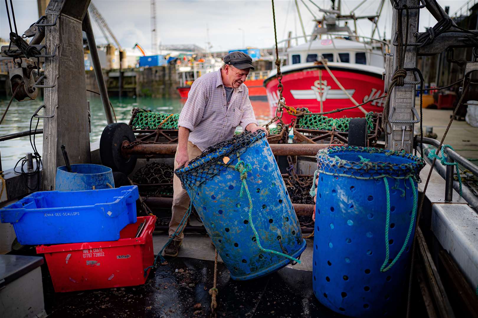 Fisherman Phil Channing unloads his catch of scallops at the harbour in St Helier (Ben Birchall/PA)