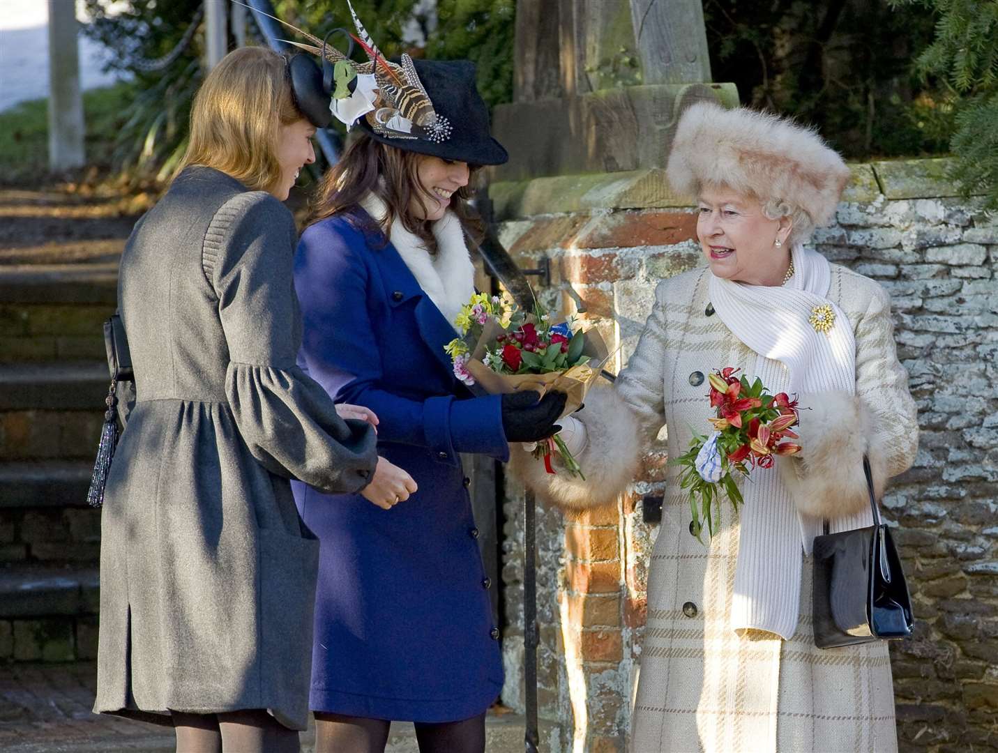 Princess Beatrice and Princess Eugenie with their grandmother the Queen on Christmas Day in 2010 (Chris Bouchier/Sunday Times/PA)